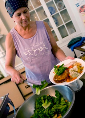 Attendee serves herself healthy food