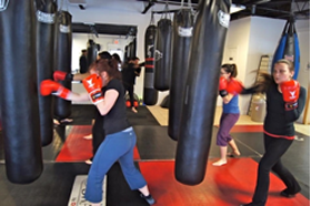 The Fight Camp ladies work the heavy bags 