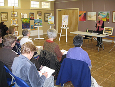 Carolyn Partan, the President of the Board at the Falmouth Artists Guild, welcomes the Cape Cod Chapter of the NLAPW to the Falmouth Art Center.